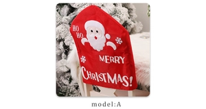 Detail of red Christmas chair cover with Santa Claus 3D appliqué and festive HO HO HO text