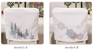 Detail of white plush Christmas chair covers with embroidered snowflake and pine patterns