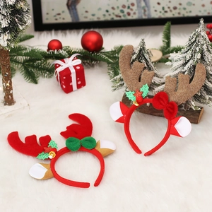Christmas reindeer antler headbands with velvet bows and bells on white plush background