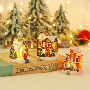 European Christmas village set with three glowing resin house miniatures and warm LED lights
