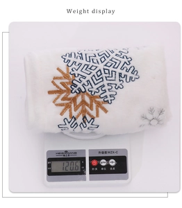 Detailed view of white faux fur chair cover featuring embroidered snowflakes on a digital scale