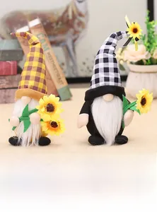 Close-up of plush harvest gnomes with sunflower accents and decorative plaid hats