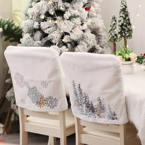 White plush Christmas chair covers with embroidered snowflakes and pine trees for home decor