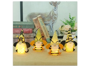 Detail of four lit bee-themed gnomes with warm LED lights for holiday decorations