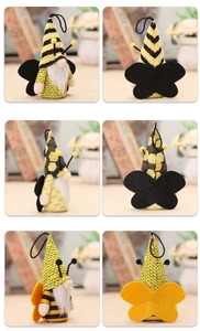 Macro detail of bee gnome plush ornaments showing knitted fabric and felt wings set of three