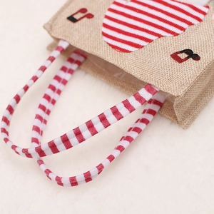 Jute style gift bag with red striped heart and music note embroidery on fabric
