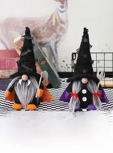 Detail of two Halloween gnomes with black hats, sequins, orange and purple capes