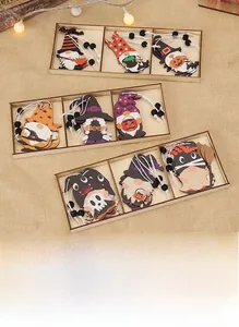 Macro shot of colorful wooden Halloween gnomes featuring pumpkins and skulls in a wooden box