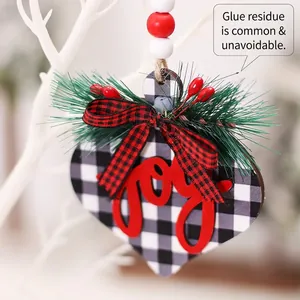 Plaid wooden heart Christmas ornament with red joy text, pine needles and berries