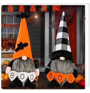 Detail of Halloween gnome figurines with BOO banner set in a festive porch scene