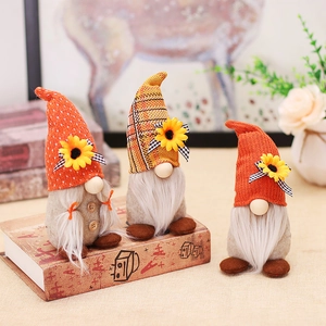 Three autumn harvest festival gnomes with sunflowers and plaid hats for home decor