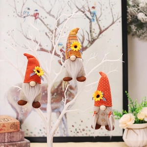 Three autumn sunflower harvest gnomes with pointed hats for Thanksgiving home decoration