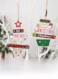 Detail of wooden Christmas tree pendants with festive text and hanging star ornaments