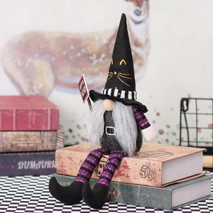 Halloween gnome doll with striped long legs and Happy Halloween sign on books