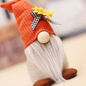 Harvest festival gnome with orange pointed hat and sunflower detail on light background