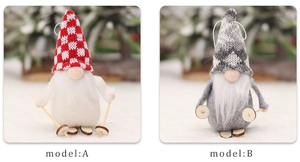 Close-up of two Christmas gnomes with knitted hats and wooden skis for holiday decor