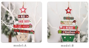 Detail of wooden Christmas tree pendants with festive greetings and rustic jute ropes