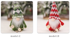 Detail of knitted Christmas gnomes with wooden skis and poles in red and green colors