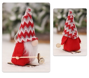 Detailed close-up of a Christmas skiing gnome with a red knitted hat and wooden skis