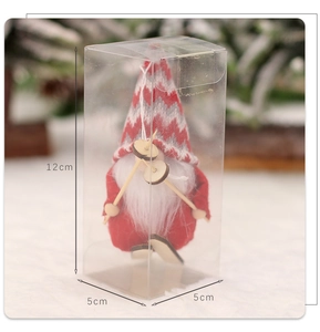 Close-up of a 12cm Christmas gnome skier with knitted hat in a clear gift display box