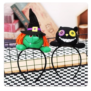 Detail of plush Halloween headbands featuring green witch and black cat embroidery designs