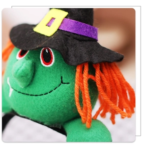 Detail shot of Halloween witch plush headpiece with green fabric and orange hair texture