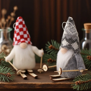 Pair of Nordic Christmas gnomes with wooden skis and knitted hats for festive decor