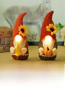 Detail of harvest gnomes featuring glowing noses and plush hats with sunflower accents