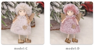 Close-up of plush angel doll ornaments with golden wings and snowflake embroidery detail