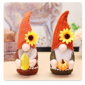 Detail of harvest gnomes featuring orange pointed hats, sunflower accents, corn and pumpkin
