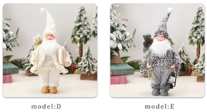 Close-up of Model D ivory gnome and Model E grey gnome with vintage lantern and gift box