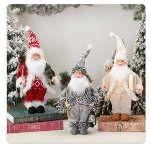 Close-up of three Christmas gnomes with lanterns and gift bags on vintage props