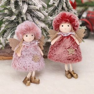 Pink plush Christmas angel dolls with gold wings on a snowy background for festive decor