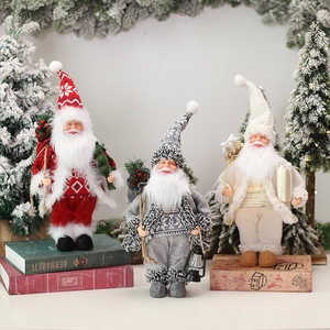 Three standing Christmas gnomes with lanterns and gift boxes for festive home decoration