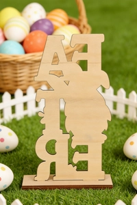 Detailed view of hollow wooden Easter bunny ornaments placed on a lush green lawn