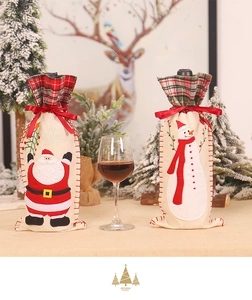 Detailed view of burlap Christmas wine bottle covers with Santa and Snowman embroidery