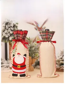 Detail of Christmas wine bottle bags with burlap fabric and Santa Claus embroidery