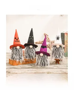 Detail view of four Halloween gnomes featuring pumpkin, bat, and spider knit hat designs