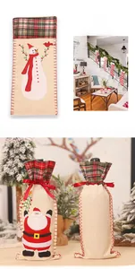 Detail of Christmas wine bottle covers with embroidered Santa and snowman on burlap