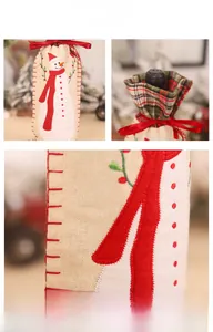 Detailed embroidery of a snowman with red ribbon on a beige linen Christmas wine bottle cover