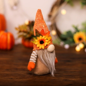 Fall harvest gnome decoration with orange sequin hat, sunflower and autumn maple leaf