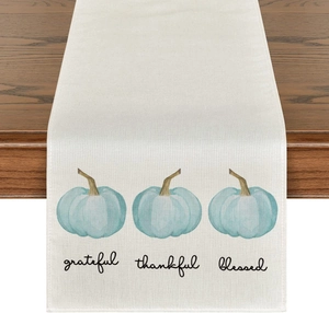 Detail of linen table runner featuring blue pumpkins and grateful thankful blessed print