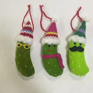 Three-piece felt Christmas pickle ornaments with knit hats and whimsical facial features