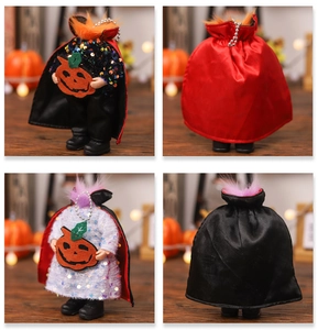 Close-up of sequined Halloween vampire dolls with satin capes and pumpkin felt details
