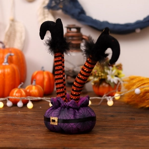 Halloween witch legs decor with orange striped boots on a purple cobweb base
