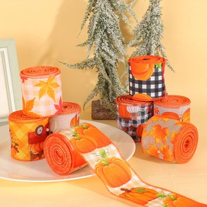 Harvest festive ribbons with pumpkins and maple leaves on plaid fabric for autumn decor