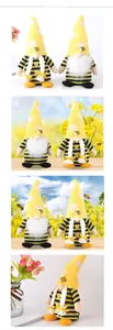 Macro detail of bee themed gnomes with yellow striped caps and white braided pigtails