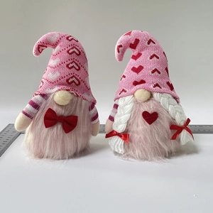 Detail view of plush Valentine's Gnomes with heart knits and ruler for scale reference