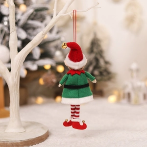 Christmas plush elf ornament with red hat and green dress hanging in festive scene