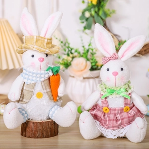 Detail of Easter bunny plush pair featuring plaid outfits and a small carrot accessory
